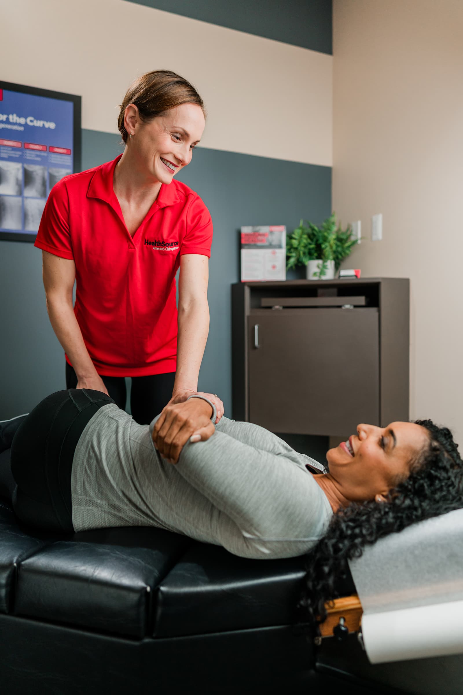 Patient lays on their side with their torso carefully turned to face the ceiling. A practitioner guides the process.