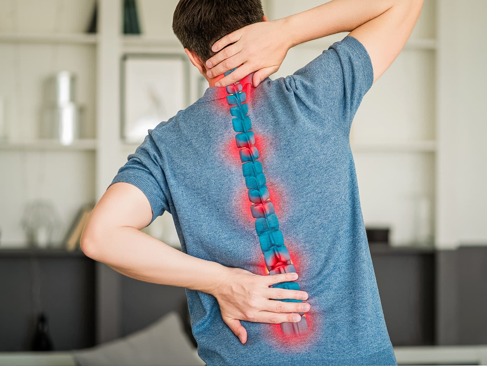 Man faces away from camera, holding his hands to his neck and lower back, where bright red painpoints are highlighted.