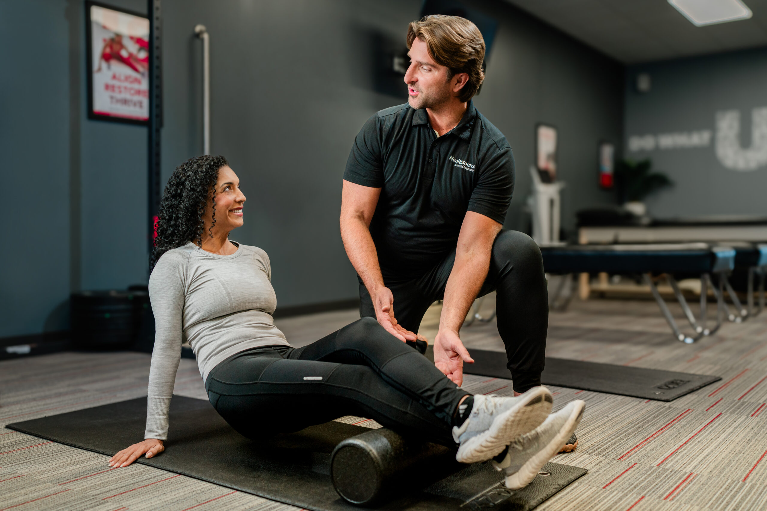 Patient smiles at employee as they work through a physical therapy session