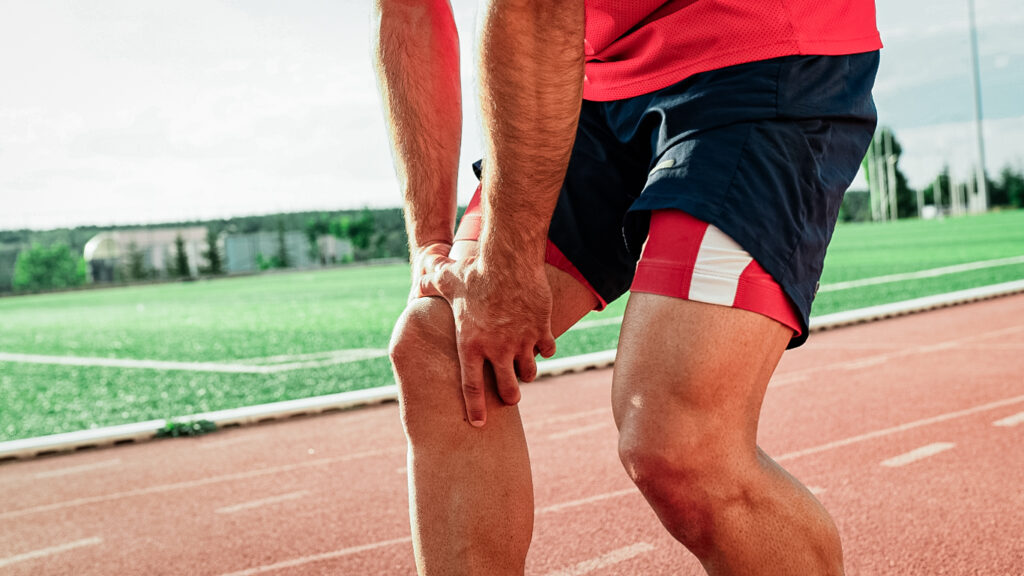 Runner experiencing pain in his right knee caused by a past sport injury.