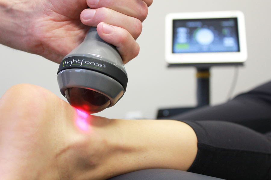 Patient receiving Laser therapy treatment on their ankle.