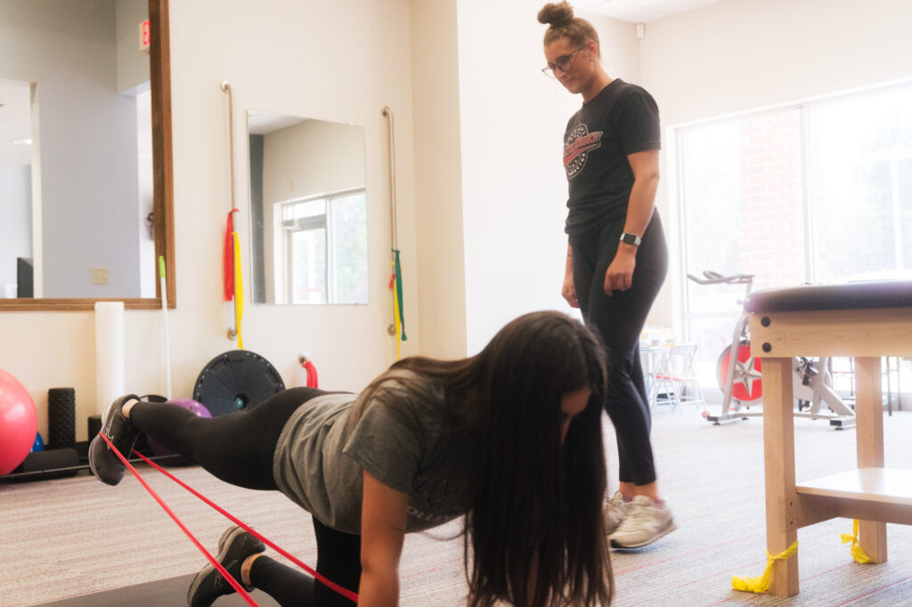 Rehabilitation Specialist at HealthSource of Avon working with a patient on stretching and strengthening