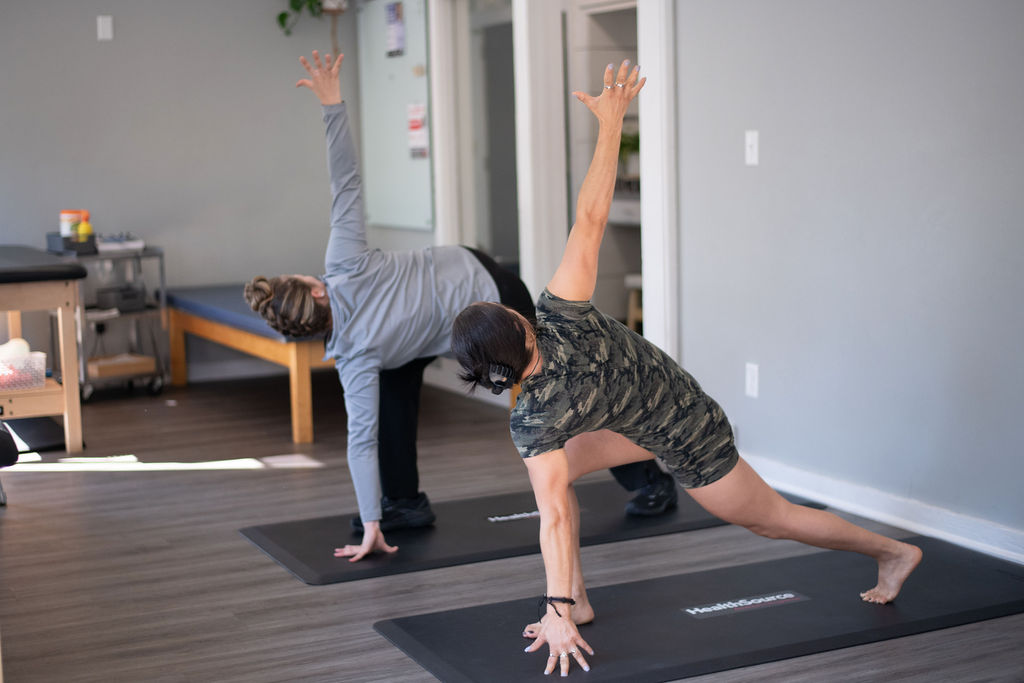 A rehabilitation specialist and patient stretching in the progressive rehab + functional exercise area at HealthSource of Boardman.