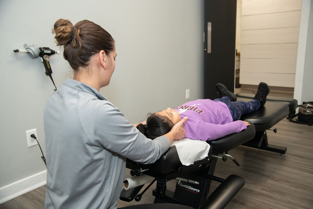 Dr. Ashley Rice, Doctor of Chiropractic, adjusting a pediatric chiropractic patient at HealthSource of Boardman