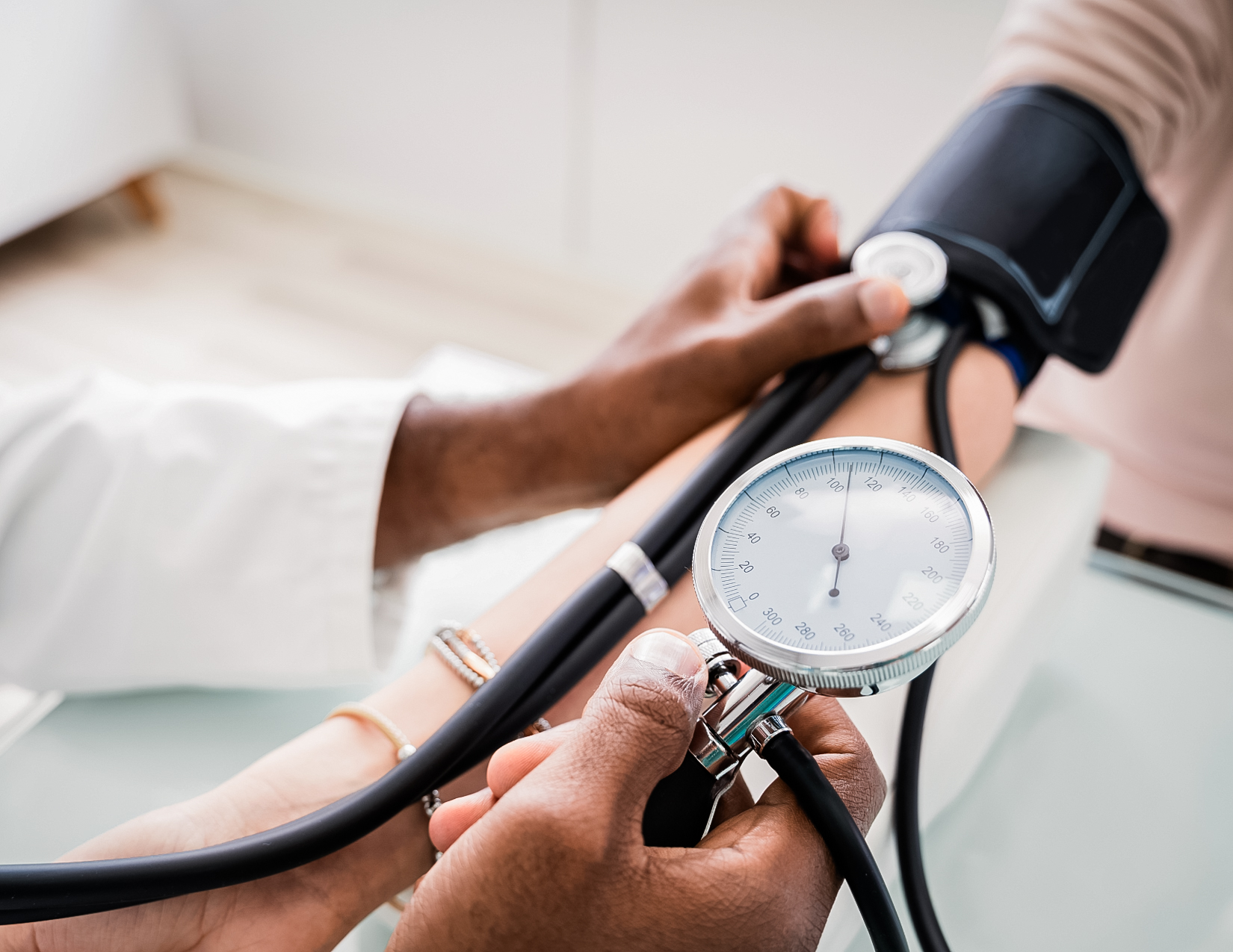 Physician checking blood pressure.