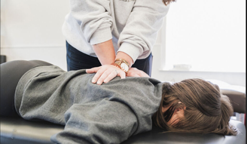 Dr. Kari Schmidt performing a Chiropractic adjustment on a patient.