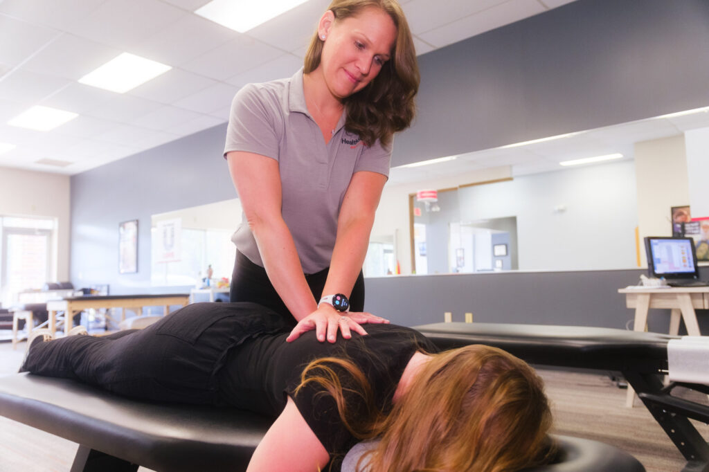 Dr. Sarah Stranko giving a patient a chiropractic adjustment at HealthSource of Avon