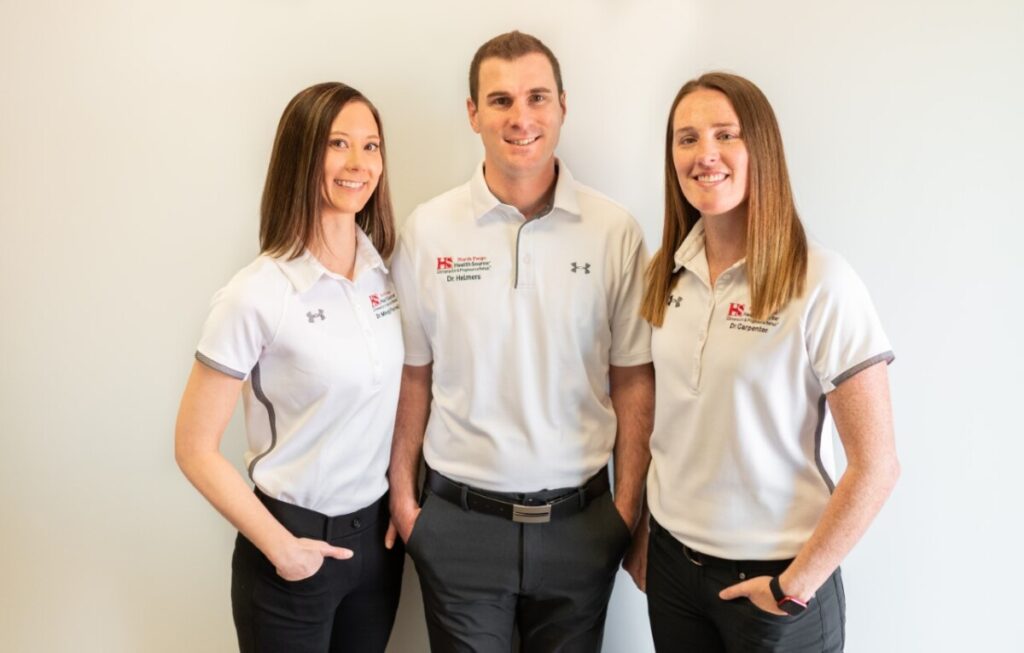 Dr. Mindy Farrell, Dr. Travis Helmers and Dr. Courtney Carpenter, Doctors of Chiropractic at HealthSource of North Fargo.