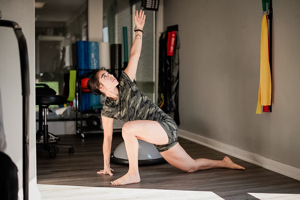 Patient in workout gear performs functional exercise.