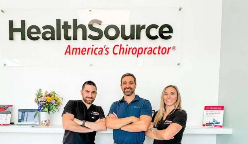 The team at HealthSource of North Milton posting together near the patient check-in area.