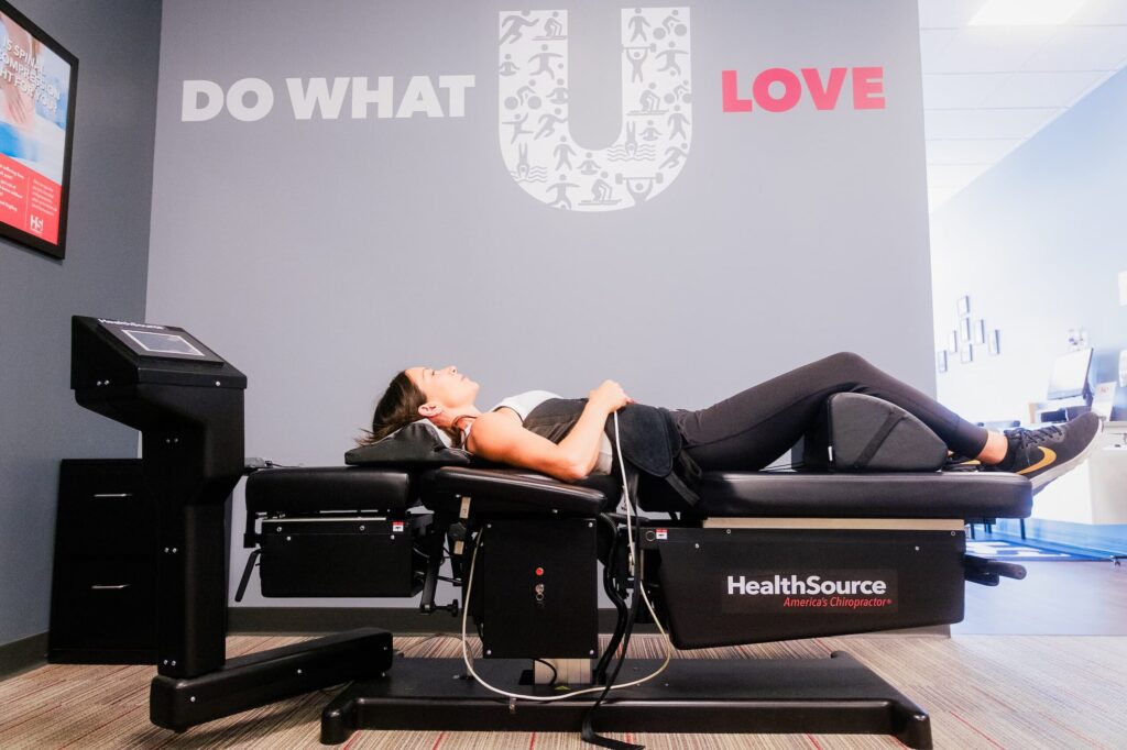 Patient lays on spinal decompression table while receiving treatment.