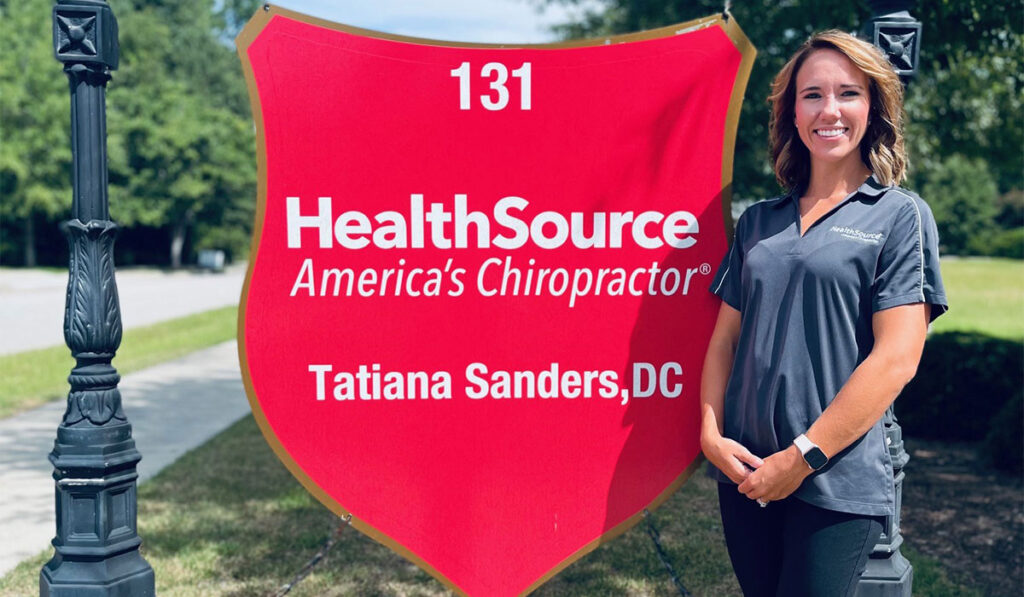 Dr. Tatiana Sanders standing outside in front of the HealthSource of Northeast Columbia sign