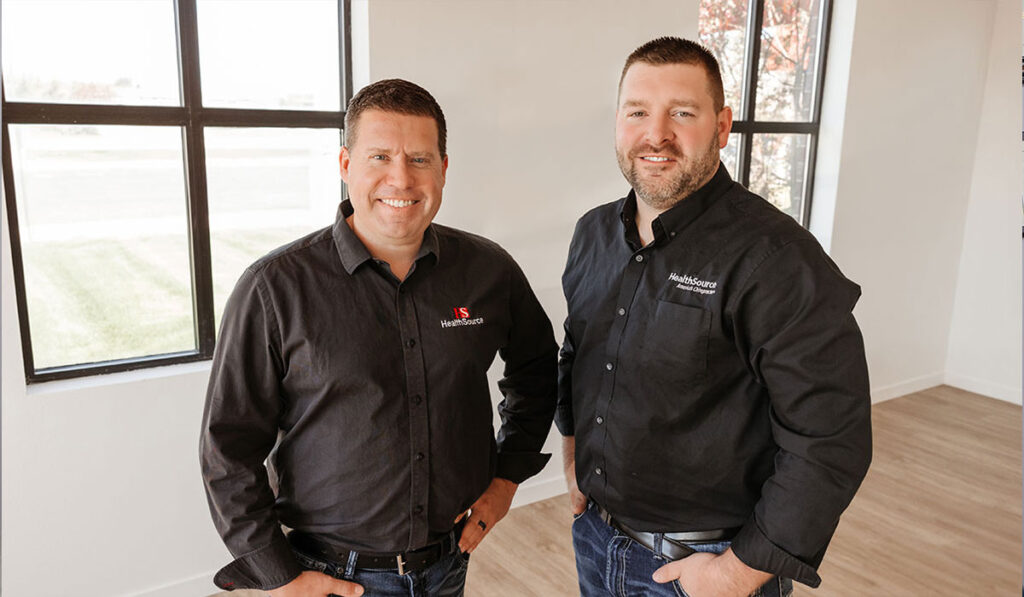 Dr. Mike Hendricks and Dr. Nick Pillatzke standing together smiling, both Dr.'s at HealthSource of Watertown.