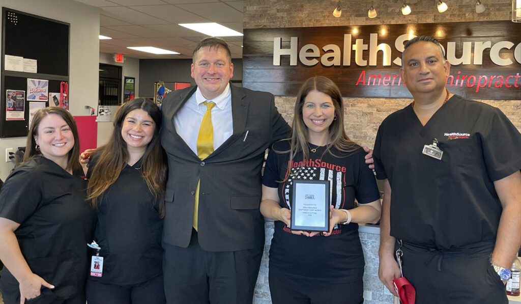 The team smiling and posting together at HealthSource of Southwest Fort Worth