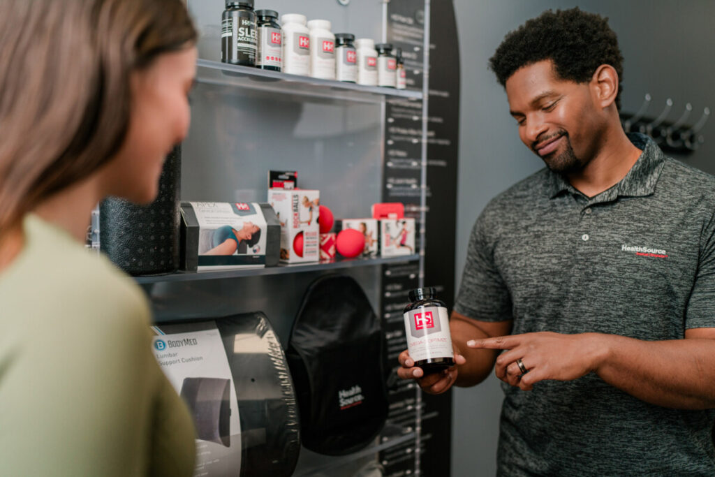 A HealthSource staff member recommends nutritional supplements to a patient